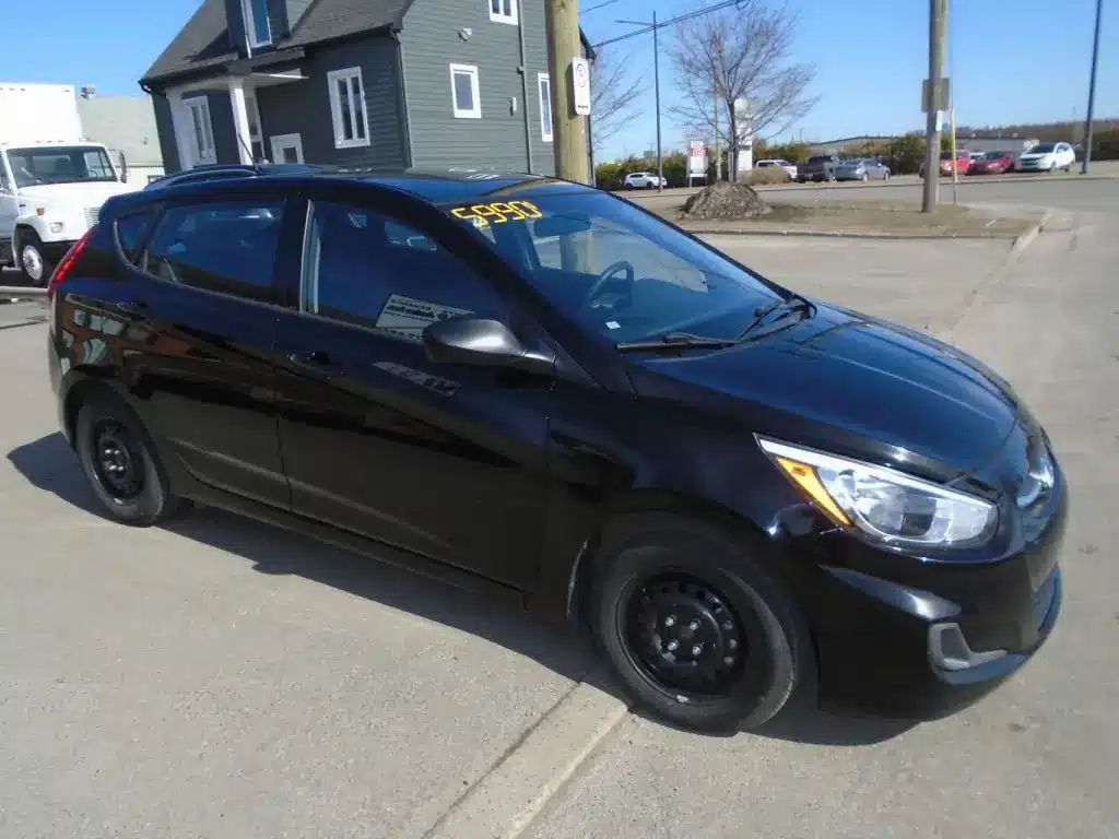 Side profile of the 2016 Hyundai Accent, emphasizing its smooth contours, wheel design, and compact sedan shape.