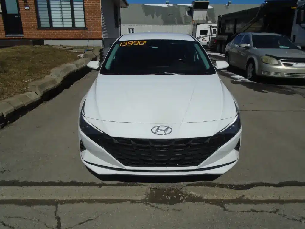 Front view of the 2021 Hyundai Elantra, showcasing its distinctive grille and sleek body lines.