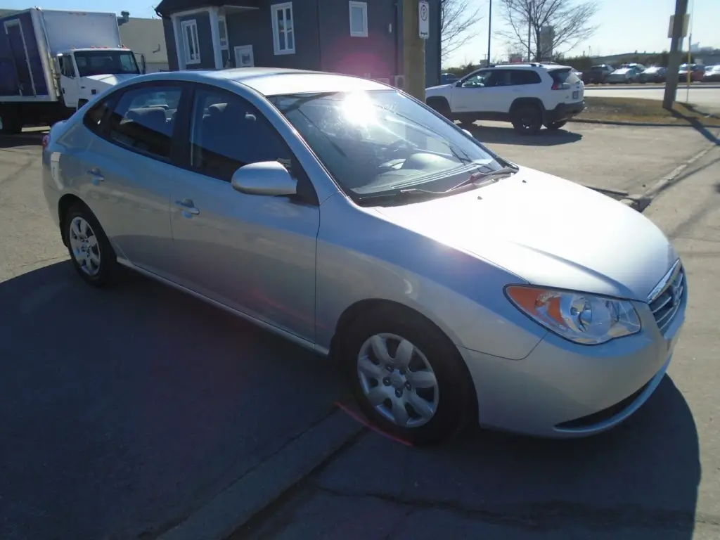 Side view of the 2009 Hyundai Elantra, highlighting its sleek profile, door lines, and wheel design.