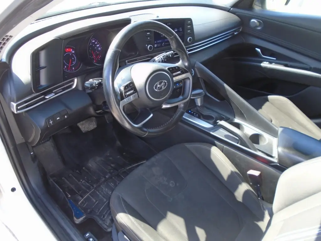 Interior view of the 2021 Hyundai Elantra, highlighting the modern dashboard, seating, and advanced technology.